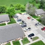 Emergency Roof Repair | Southwest Missouri | Teague Roofing Plus 18 Aerial view of an apartment complex with asphalt shingle roofs and parking