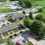 Emergency Roof Repair | Southwest Missouri | Teague Roofing Plus 16 Aerial view of a rural commercial property and parking area