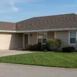 Single story home with an attached garage and a light shingle roof
