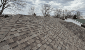 Home | Teague Roofing Plus 58 Close view of an asphalt shingle roof field and ridge
