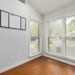 Living space with a bank of replacement windows and blinds