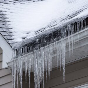 Ice dams and icicles forming along the eave of a southwest missouri roof