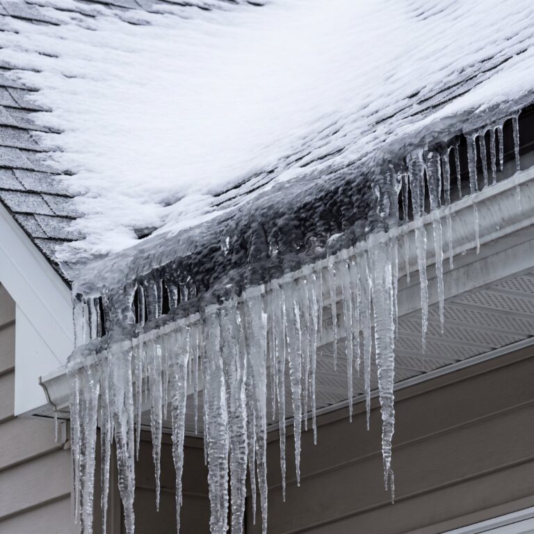 Ice dams and icicles forming along the eave of a Southwest Missouri roof
