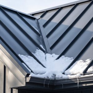 Standing seam metal roofing shedding snow in cold weather