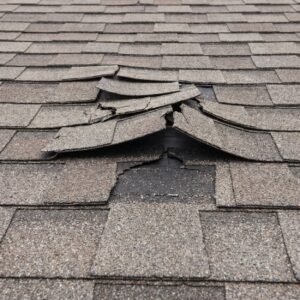 Aging roof with curling shingles and granule loss before a missouri winter