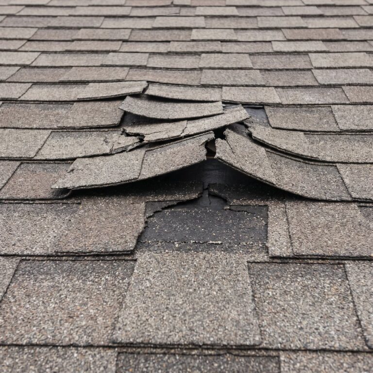 Aging roof with curling shingles and granule loss before a Missouri winter