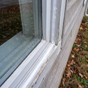 Window sealing with fresh caulk applied around an exterior window frame