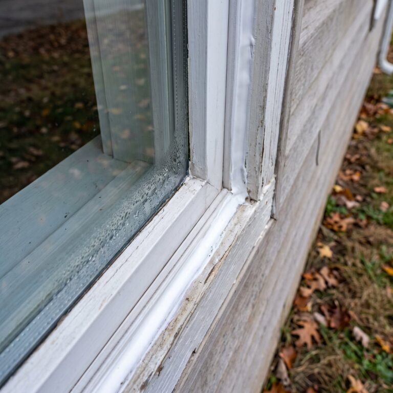 Window sealing with fresh caulk applied around an exterior window frame